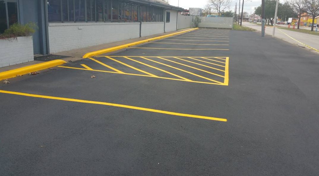 sealcoat being applied to a parking lot in Newport News